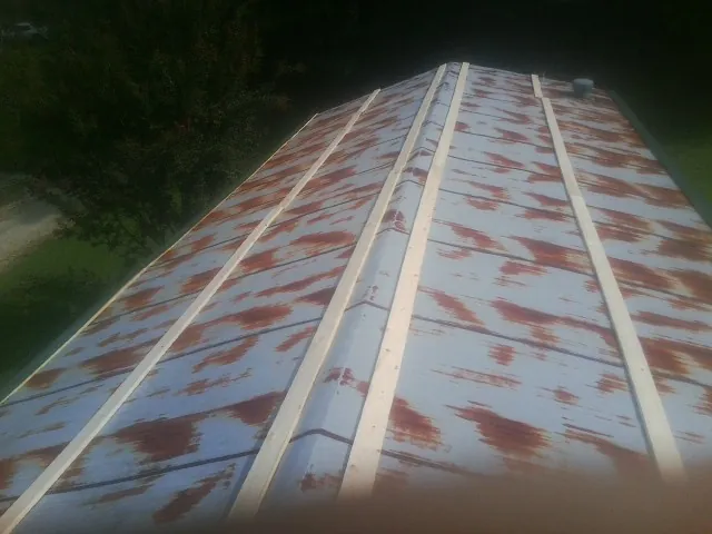 Rusted metal roof panels with new wood purlins before replacement — Storm Damage Roof Repair in Closter by Roofing Brothers