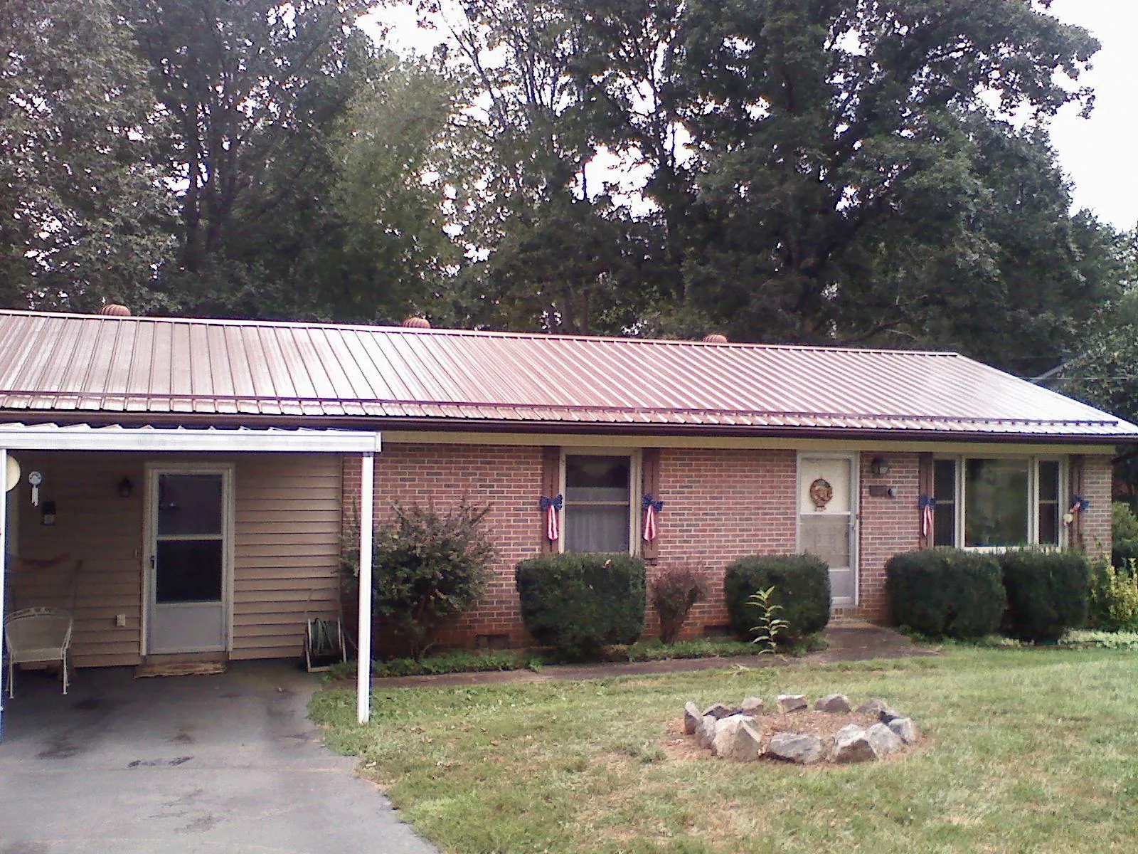Bronze metal roof and carport on a brick ranch home — Roof Repair work by our crew in Closter
